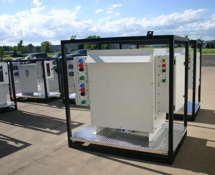 Industrial electrical distribution enclosure with colored indicator lights and control panel mounted on metal platform frame