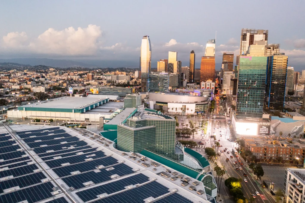 Solar panels on commercial rooftop overlooking downtown skyline and urban power solutions infrastructure